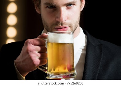 Man Or Businessman With Beard In Formal Outfit Hold Beer Glass Near Mirror With Lamps, Meeting And Relax, Bar And Restaurant, Sommelier, Tasting And Degustation