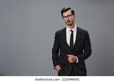 Man Businessman In Business Suit And Eyeglasses With Brunette Beard On Gray Background. The Concept Of Good Business And Expensive Clothes A Copy Space