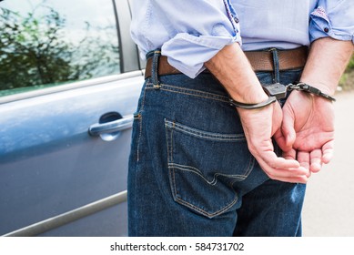 The man, a businessman in handcuffs. The arrest of the car.