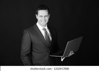 Man, Businessman Or Manager Smiling With Laptop Or Computer On Black Background. Technology For Business. Formal Violet Suit And Dress Code. Internet Surfing