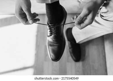 A Man, A Businessman Tying His Shoelaces, Going To Work. Monochrome Photography, Top View, Business.