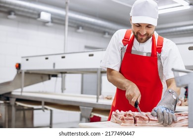 Man butcher at the freezer cutting meat - Powered by Shutterstock