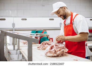 Man butcher at the freezer cutting meat