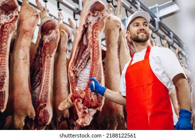 Man butcher standing in meat freezer holding hook - Powered by Shutterstock