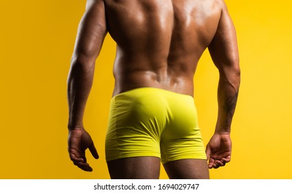 Man Buttocks In Yellow Underpants. Muscular Man With Muscular Buttocks. Bare Nude Torso, Naked Male Ass