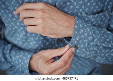 Man buttoning up cuff