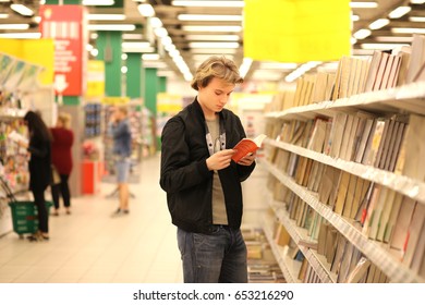 Man Buying A Book In A Store