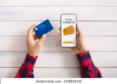 Man Buying Event Tickets With App On Smartphone And Credit Card, White Wooden Background With Free Space