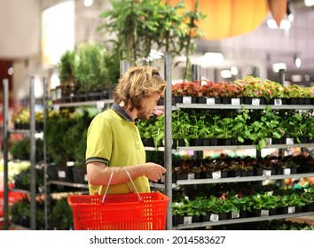 Man Buying Flowers At A Garden Center .