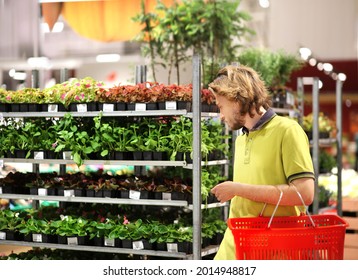 Man Buying Flowers At A Garden Center .