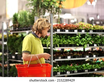 Man Buying Flowers At A Garden Center .