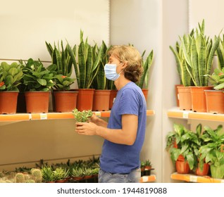 Man Buying Flowers At A Garden Center,supermarket Shopping, Face Mask And Gloves.	