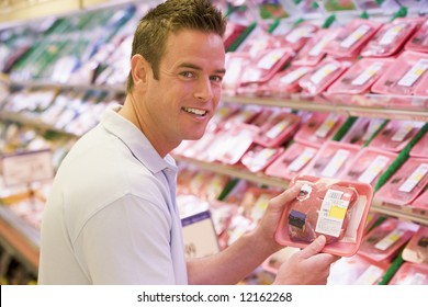 Man Buying Fresh Meat From Supermarket Counter