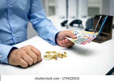 Man buying gold jewellry, pawn shop and euro banknotes