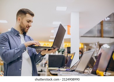 Man Buying Laptop At Electronic Store