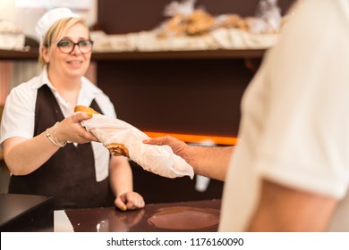 Man Buying A Loaf Of Bread In A Bakery