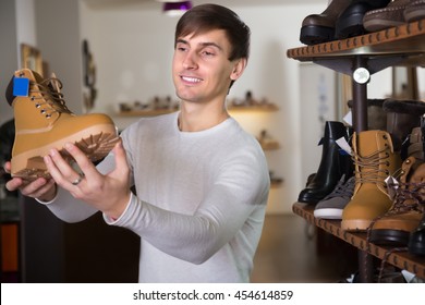 Man Buying Winter Shoes In A Shoe Shop