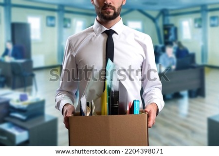 Man by dismissal. Guy lost job. Fired manager in company. Dismissal box in hands of employee. Man office worker disappointed by dismissal. Fired male in blurred office. Discharge company employees Foto d'archivio © 