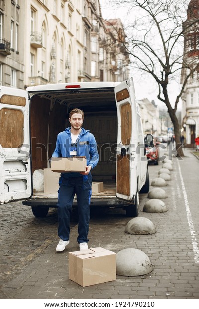 Man by the\
truck. Guy in a delivery\
uniform.