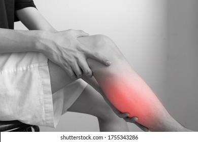 Man With Calf Feeling Pain. Man Hold And Massage His Leg After Exercise. Young Man Suffering From Chronic Leg Pain. Inflammation Or Arthritis. Healthcare And Insurance Concept For Graphic Design.