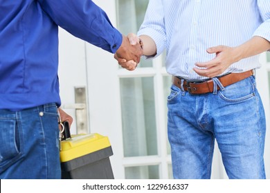 Man Called The Service To Repair The House And Greeting Technician With Toolbox Near His House