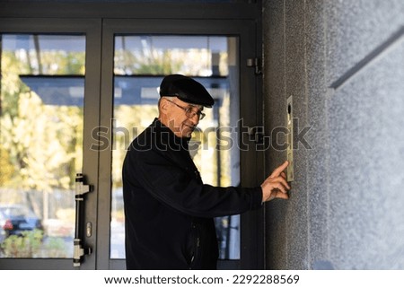 man calling by the intercom, from an apartment building