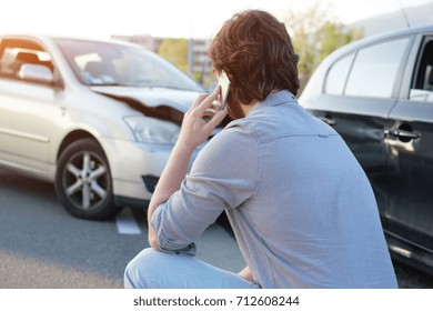 Man calling help after a car crash accident on the road