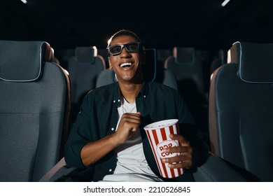 The man came to the meaning of the movie in the cinema with popcorn. High quality photo - Powered by Shutterstock