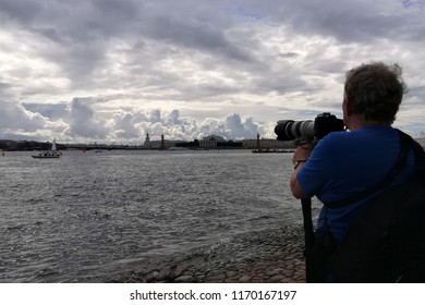 man with a camera in the waters of the river