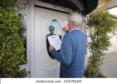 Man Canvassing A Neighborhood Taking A Poll