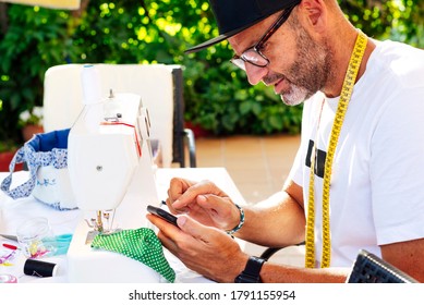 Man With Cap Sewing Face Masks At Her Home