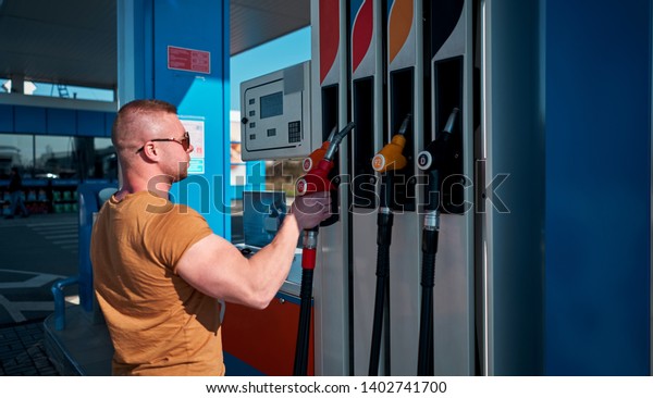 man at the car\
holding a gun gas station
