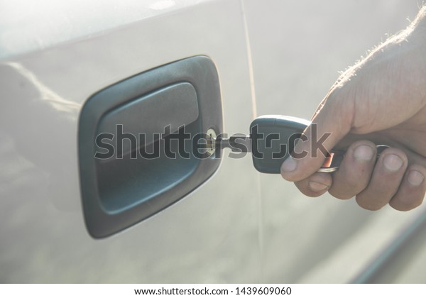 Man with car key. Opening\
car door 