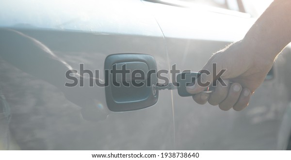 Man with car key. Opening
car door 