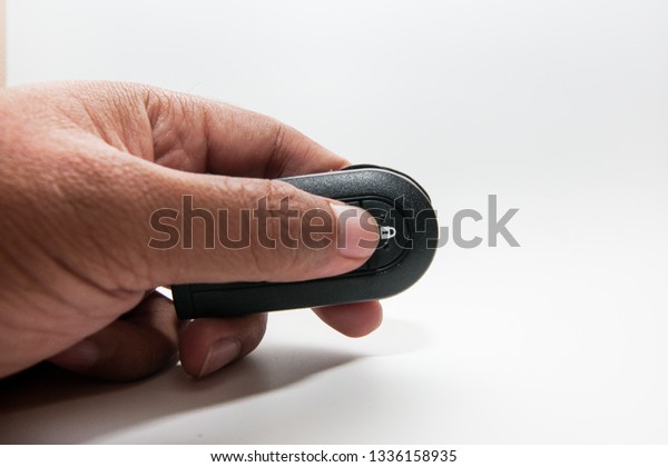Man\
with car keys (remote), isolated on white background\

