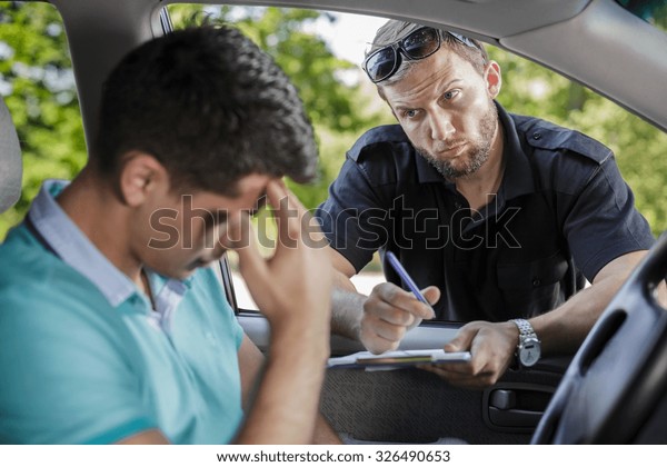Man in a\
car and the policeman with traffic\
ticket
