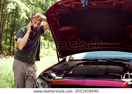  Man with a car problem using the phone for help                              