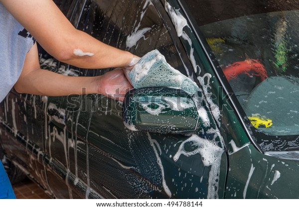 Man Car washing with
sponge