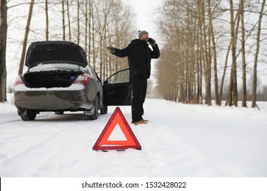 Man And Car. Winter Road Walk And Car Repair.