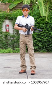 Man In Cargo Pants With Gun