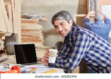 Man as carpenter taking a coffe break and relaxing - Powered by Shutterstock