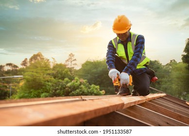 Man Carpenter Works The Roof Truss On The Roof Truss Construction Site.A