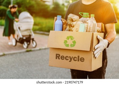a man carries garbage in a box for sorting. The concept of caring for the environment and ecology. High quality photo