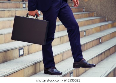 Man Is Carry Brief Case Walking Downstairs