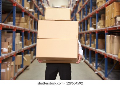 Man Carrying Boxes In Warehouse