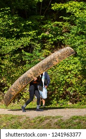 Man Carrying A Camouflaged Canoe