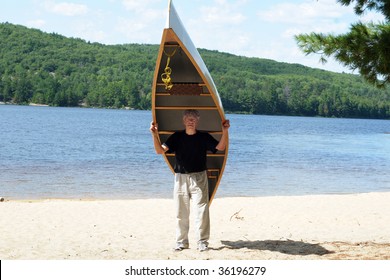 Man Carrying A Canoe