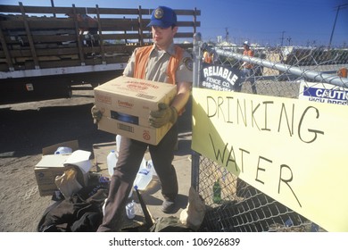 A Man Carrying Drinking Water Away From A Relief Station In Santa Clara After The 1994 Earthquake