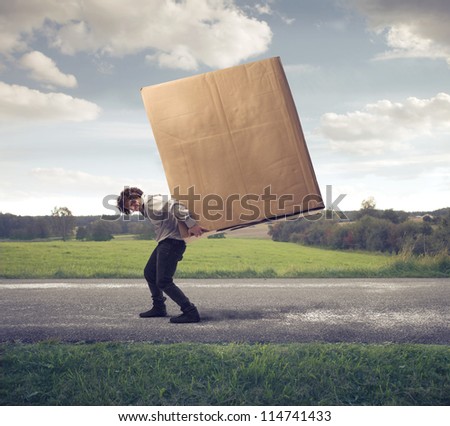 Man carrying on his shoulders a large box