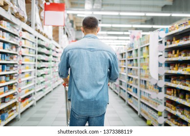 Man With Cart In Supermarket, Back View